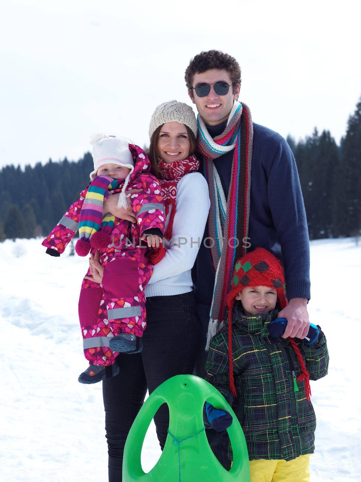 Winter playing, fun, snow and family portrait  sledding at winter time