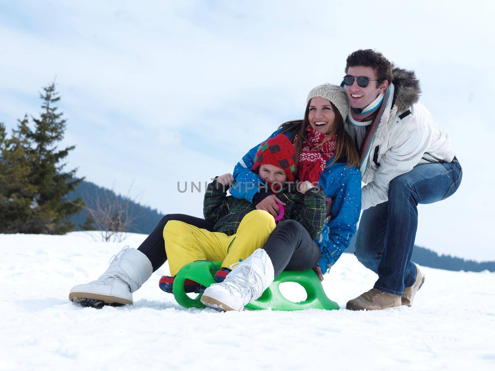 Winter playing, fun, snow and family portrait  sledding at winter time