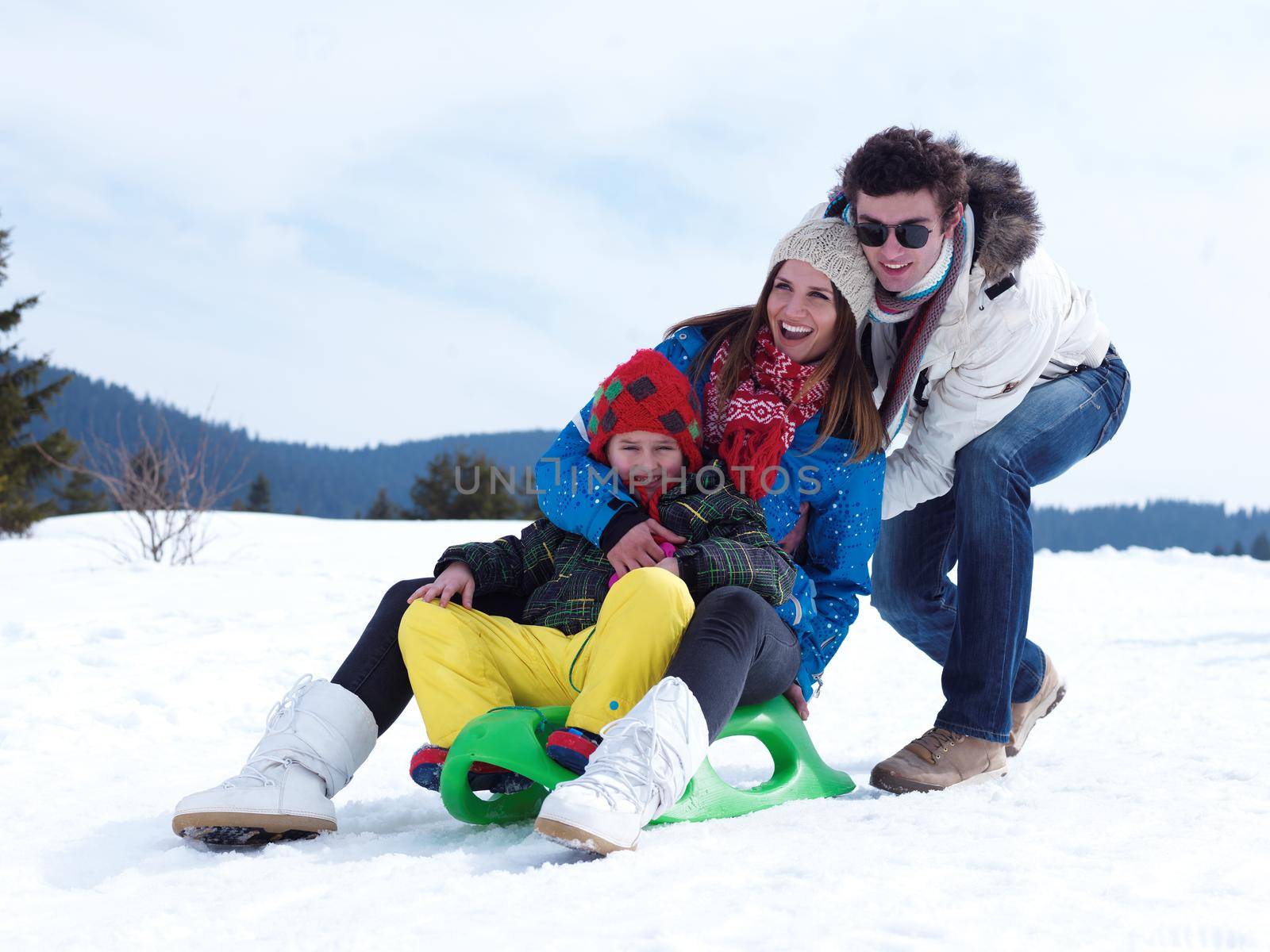 Winter playing, fun, snow and family portrait  sledding at winter time