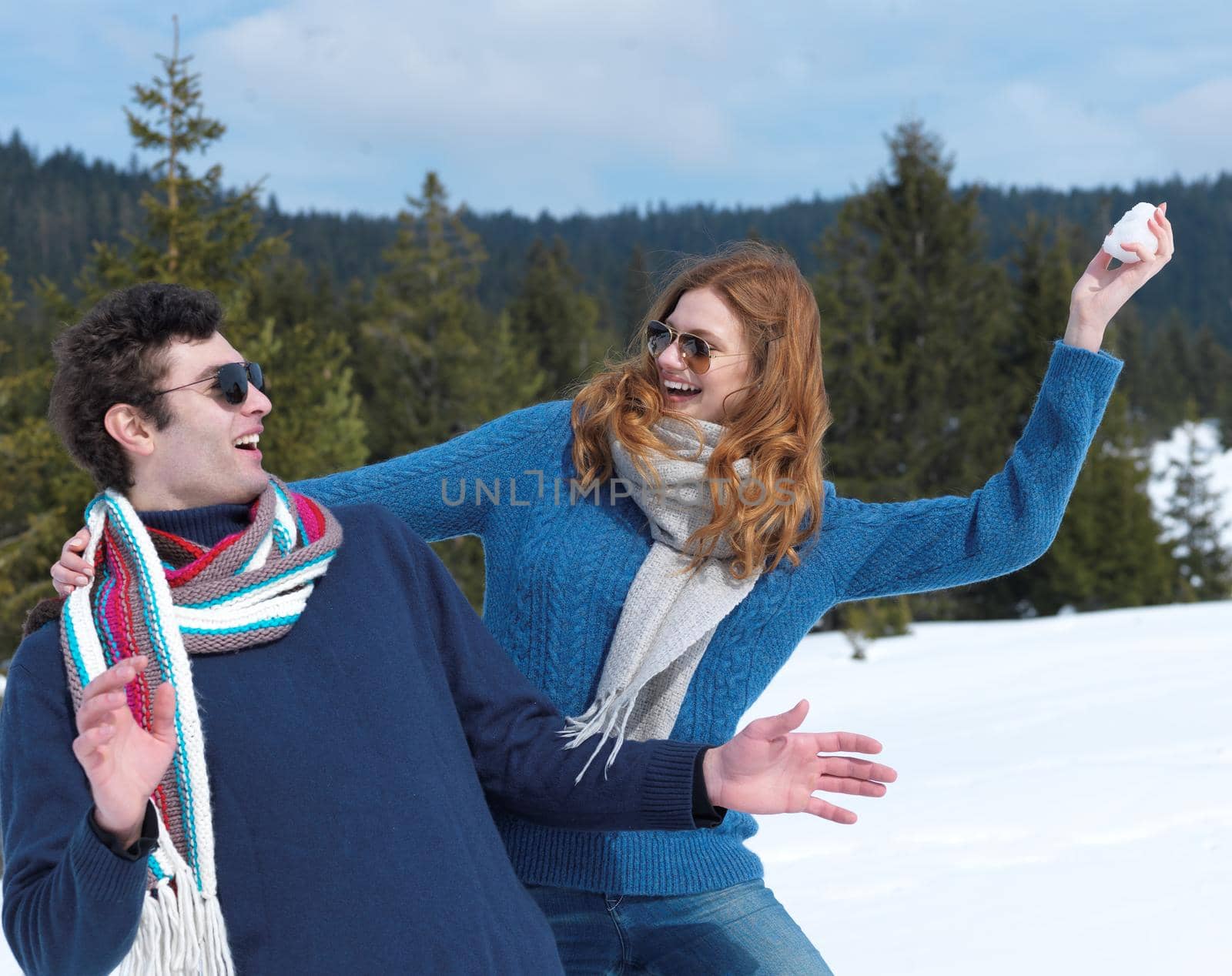 romantic winter  scene, happy young couple having fun on fresh show on winter vacatio, mountain nature landscape