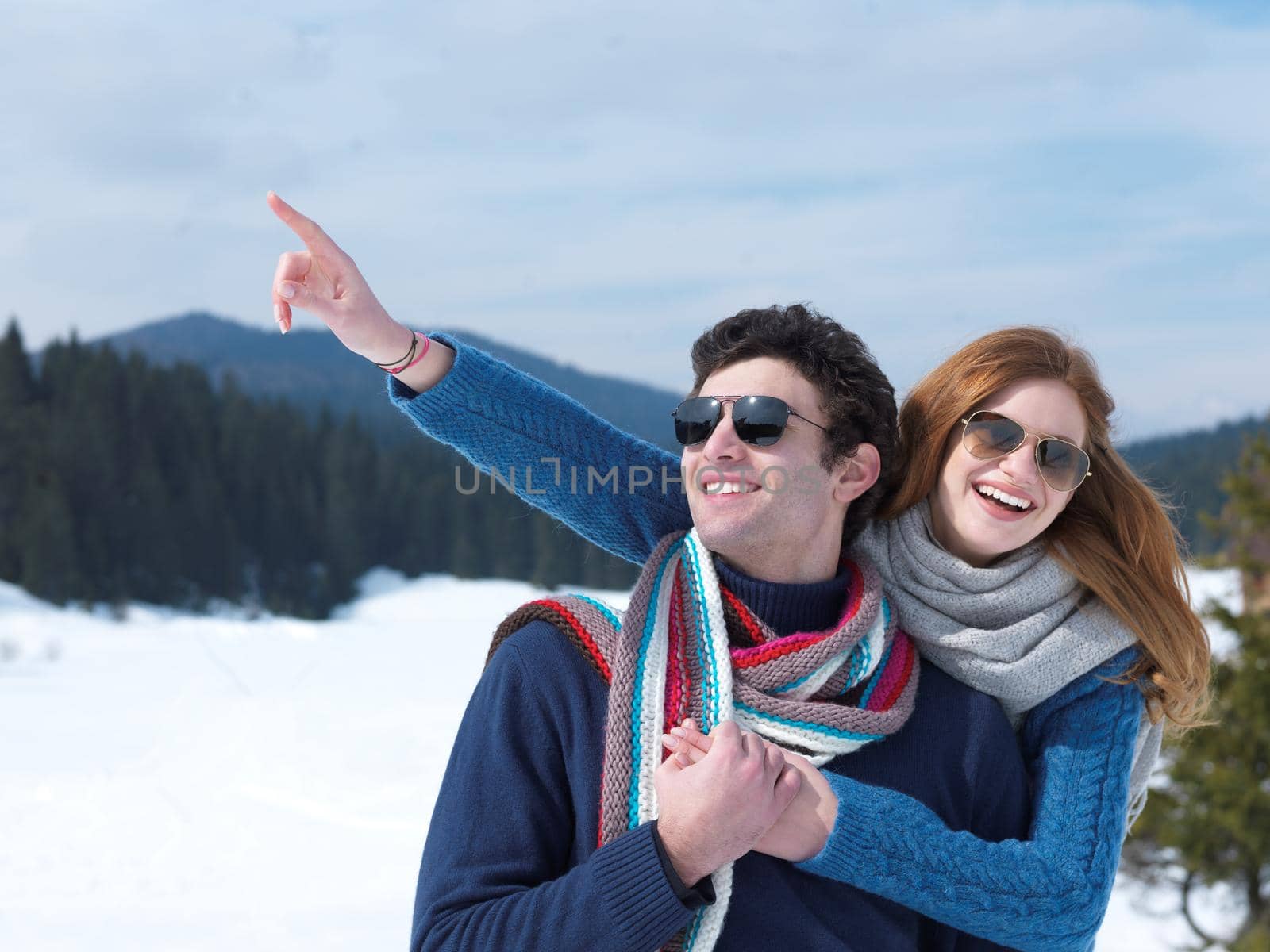 romantic winter  scene, happy young couple having fun on fresh show on winter vacatio, mountain nature landscape