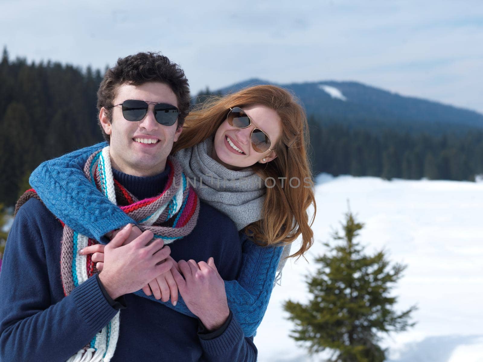 romantic winter  scene, happy young couple having fun on fresh show on winter vacatio, mountain nature landscape