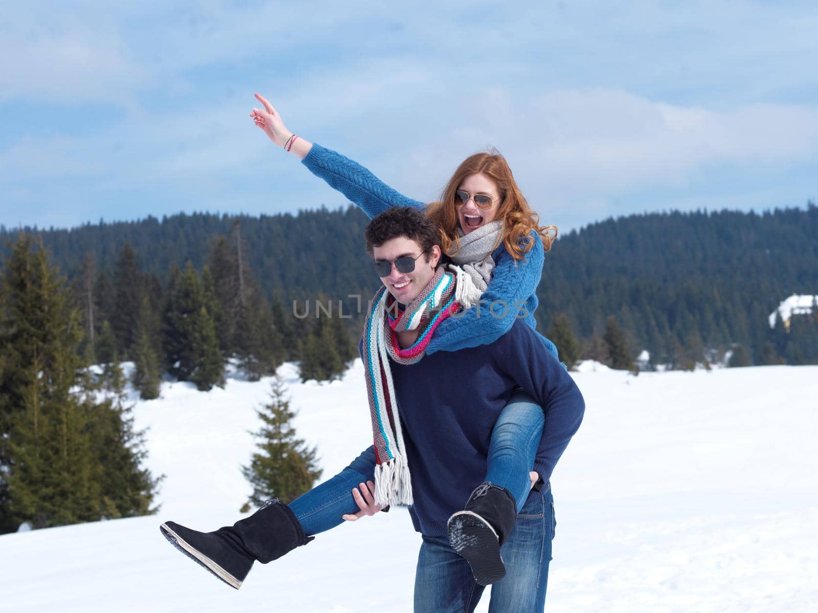 romantic winter  scene, happy young couple having fun on fresh show on winter vacatio, mountain nature landscape