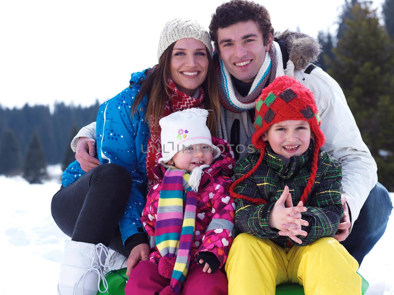 Winter playing, fun, snow and family portrait  sledding at winter time