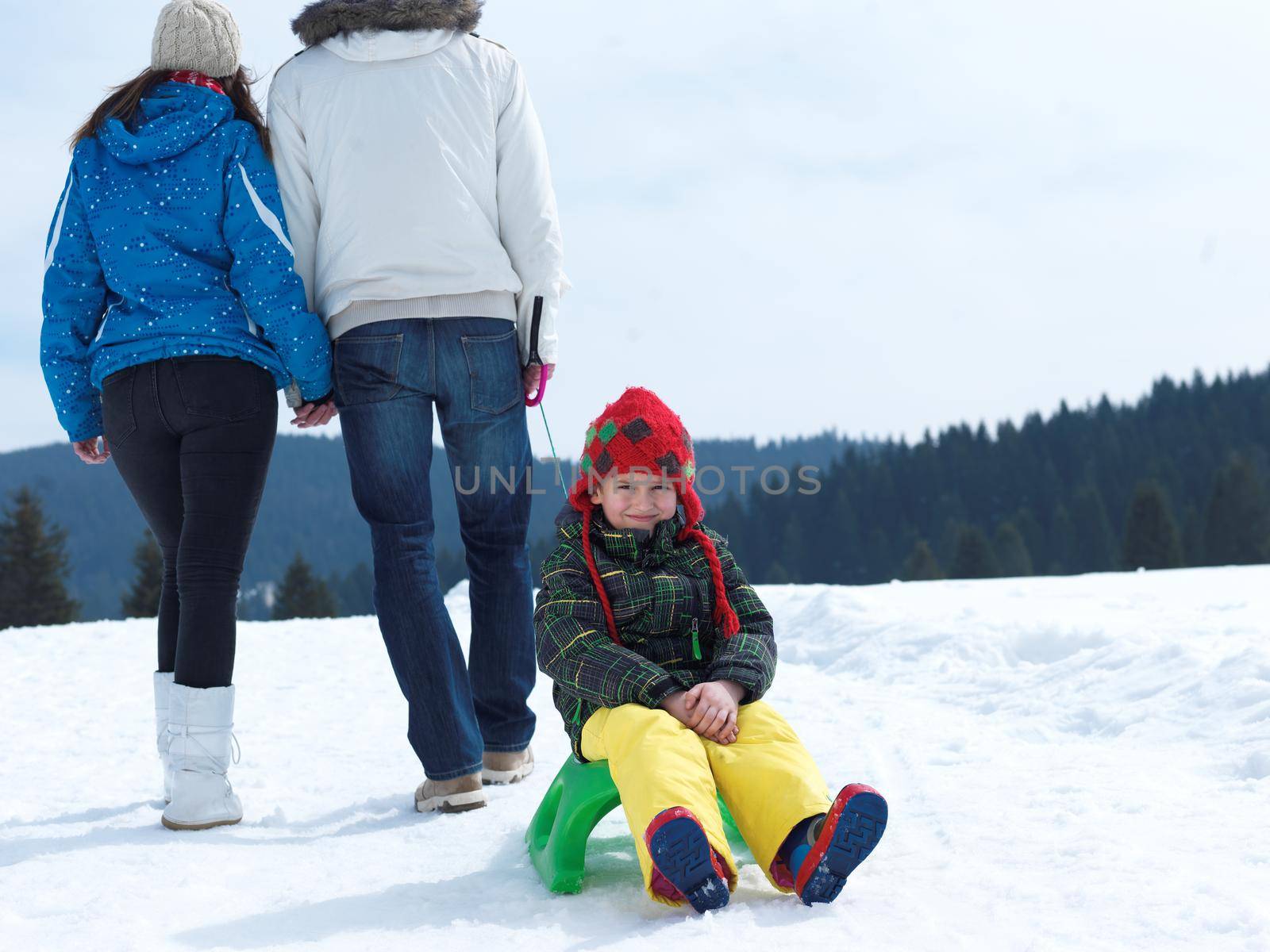 Winter playing, fun, snow and family portrait  sledding at winter time