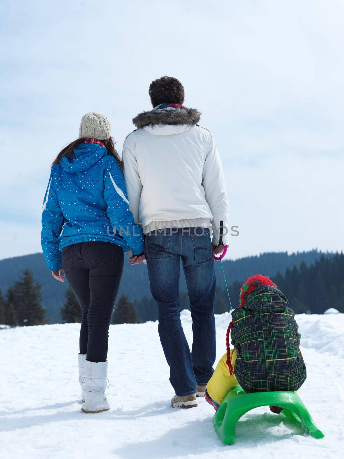 Winter playing, fun, snow and family portrait  sledding at winter time