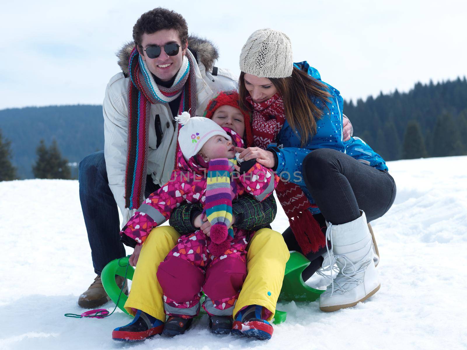 Winter playing, fun, snow and family portrait  sledding at winter time