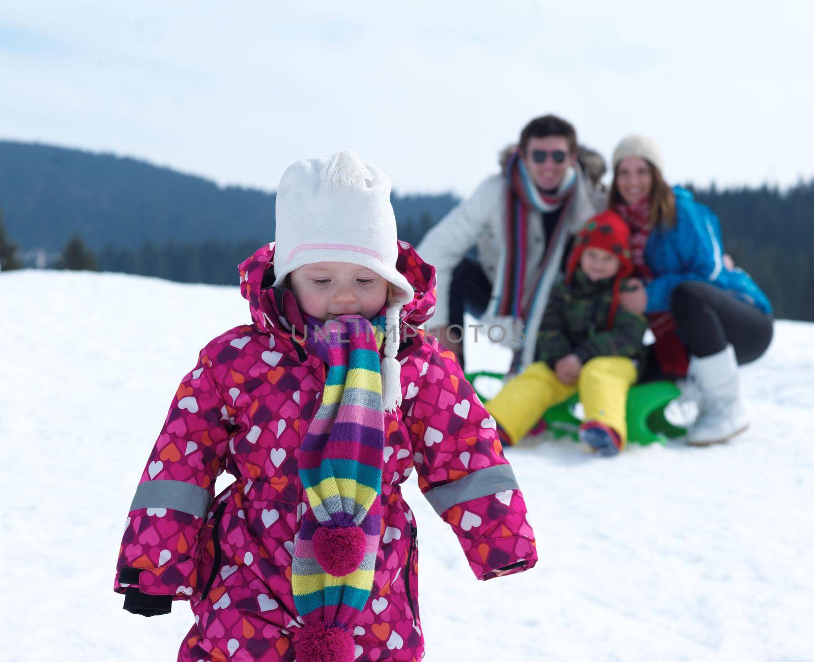 Winter playing, fun, snow and family portrait  sledding at winter time