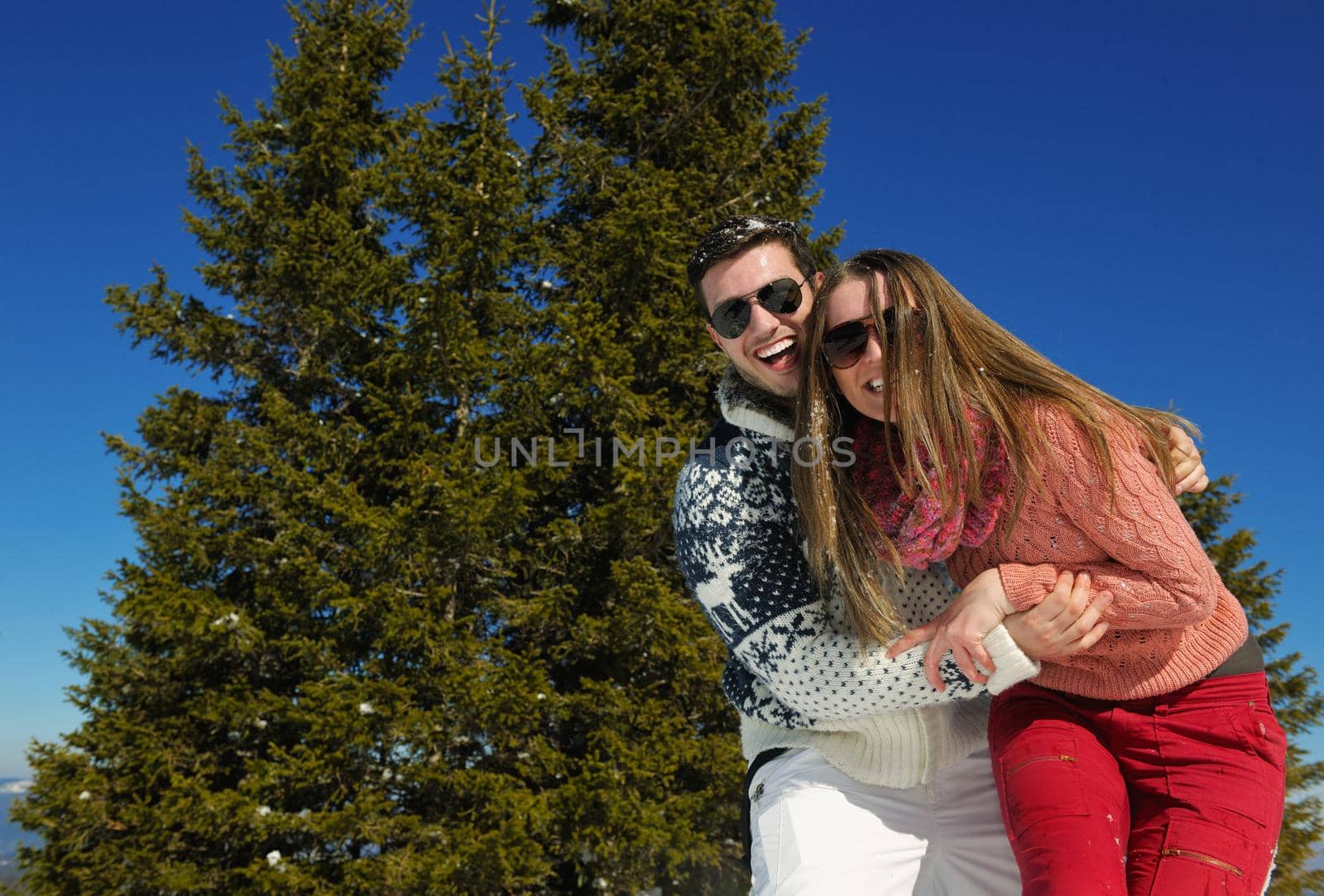 Young Couple In winter Snow Scene at  beautiful sunny day