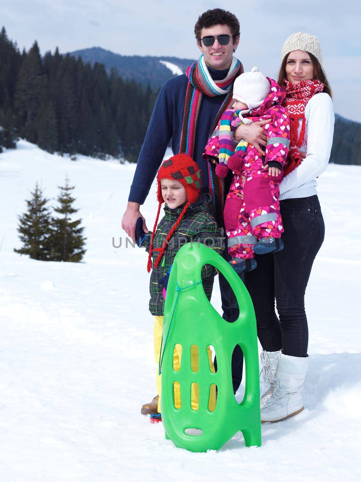 Winter playing, fun, snow and family portrait  sledding at winter time