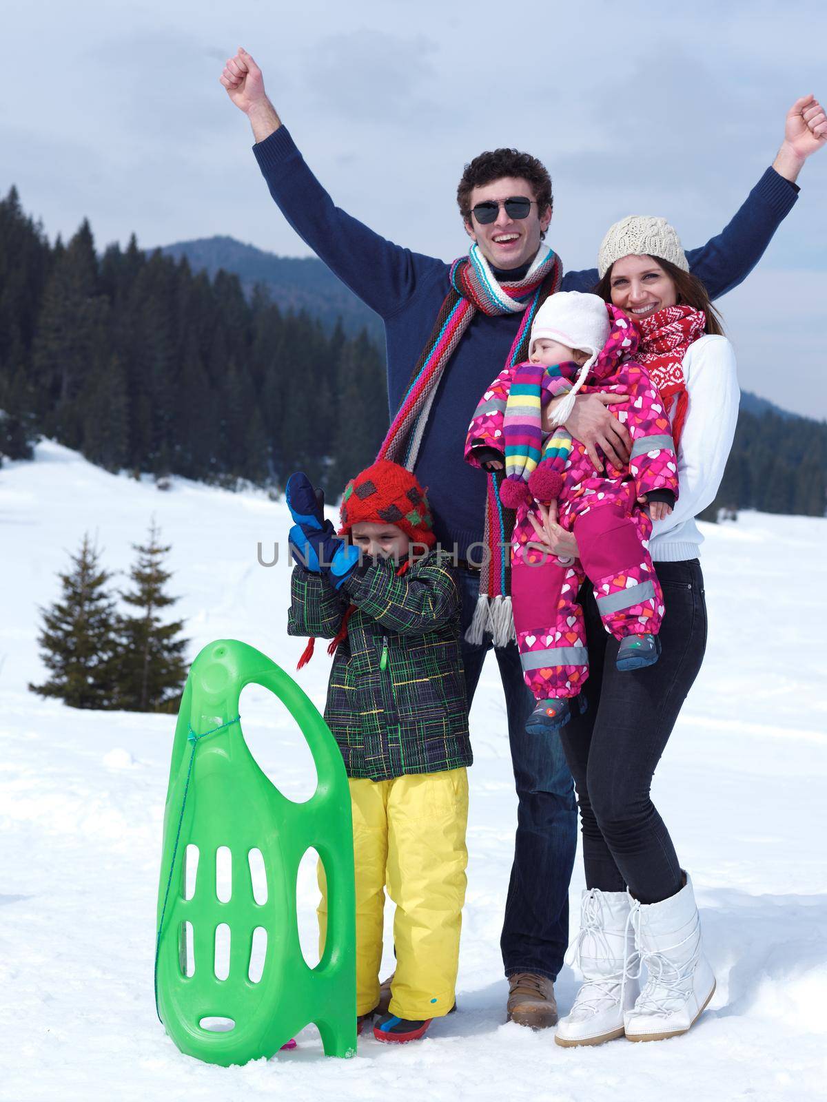 Winter playing, fun, snow and family portrait  sledding at winter time