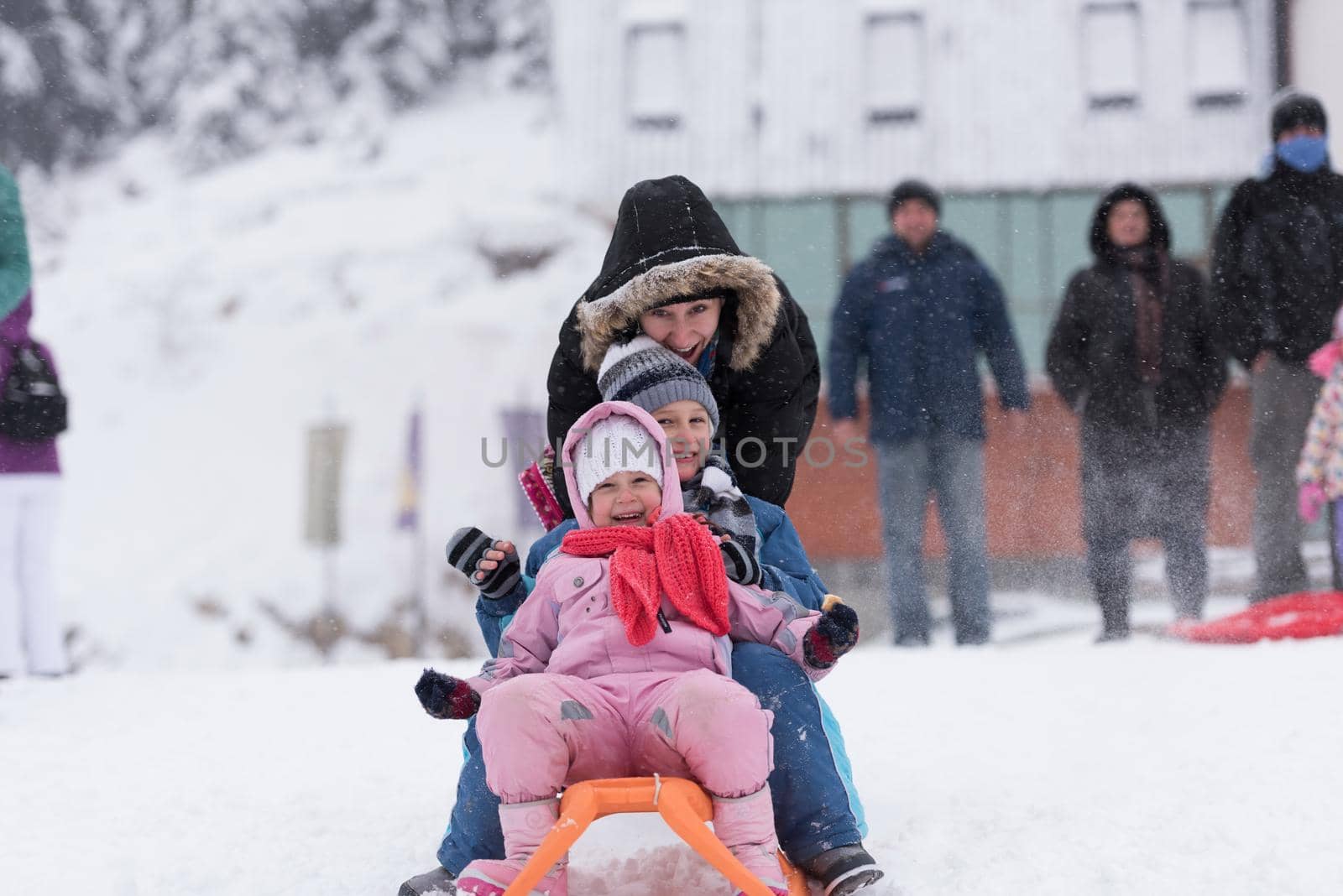 group of kids having fun and play together in fresh snow on winter vacation