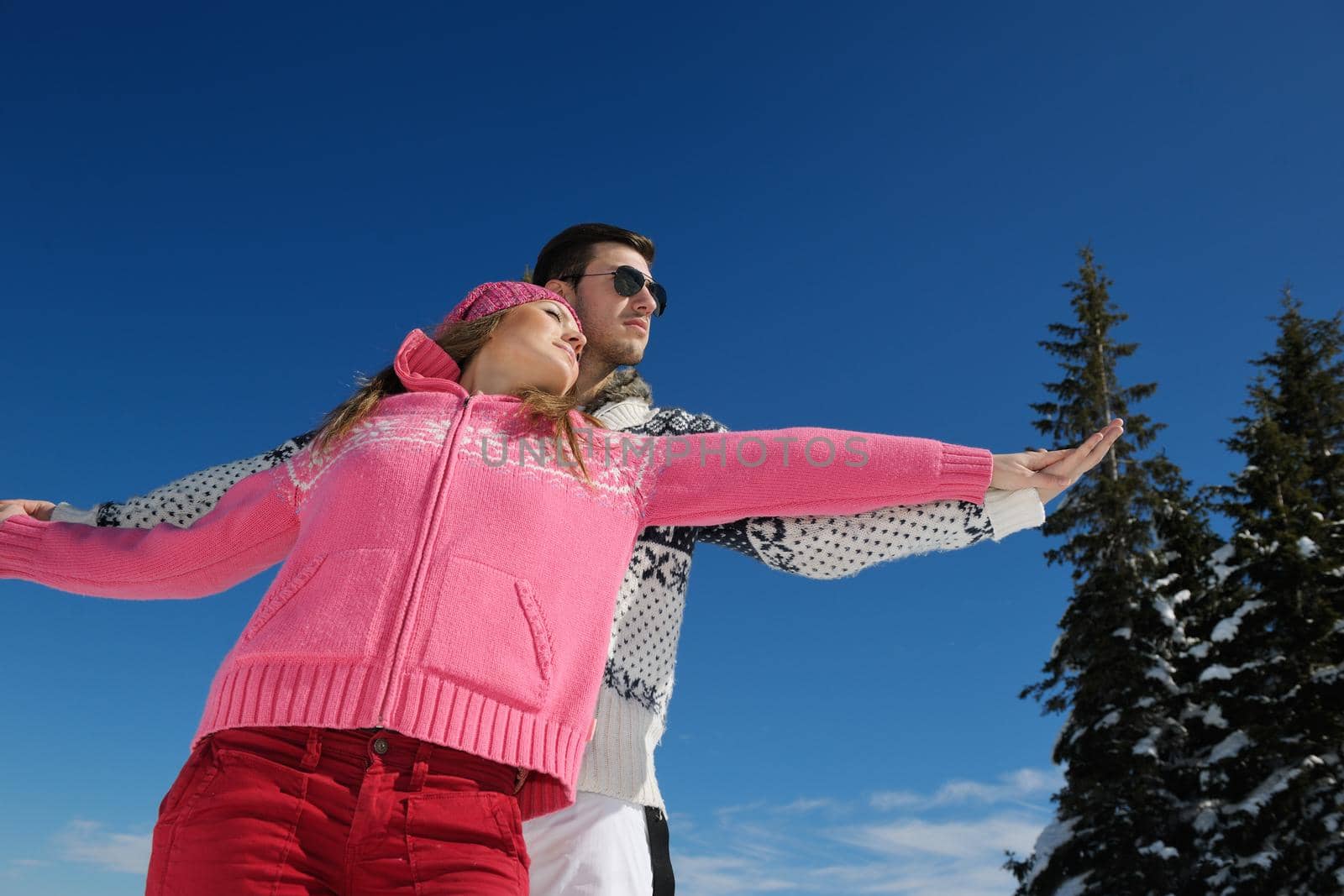 Young Couple In winter Snow Scene at  beautiful sunny day