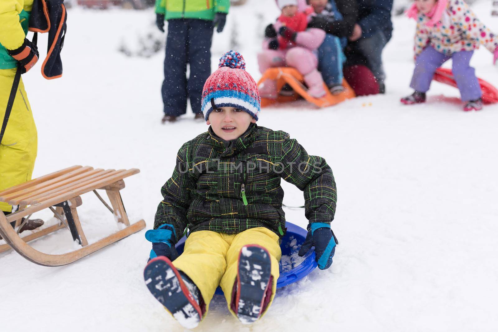 portrait of happy smiling little boy child outdoors having fun and playing on snowy winter day