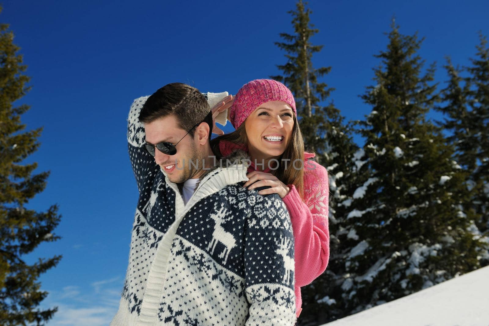 Young Couple In winter Snow Scene at  beautiful sunny day