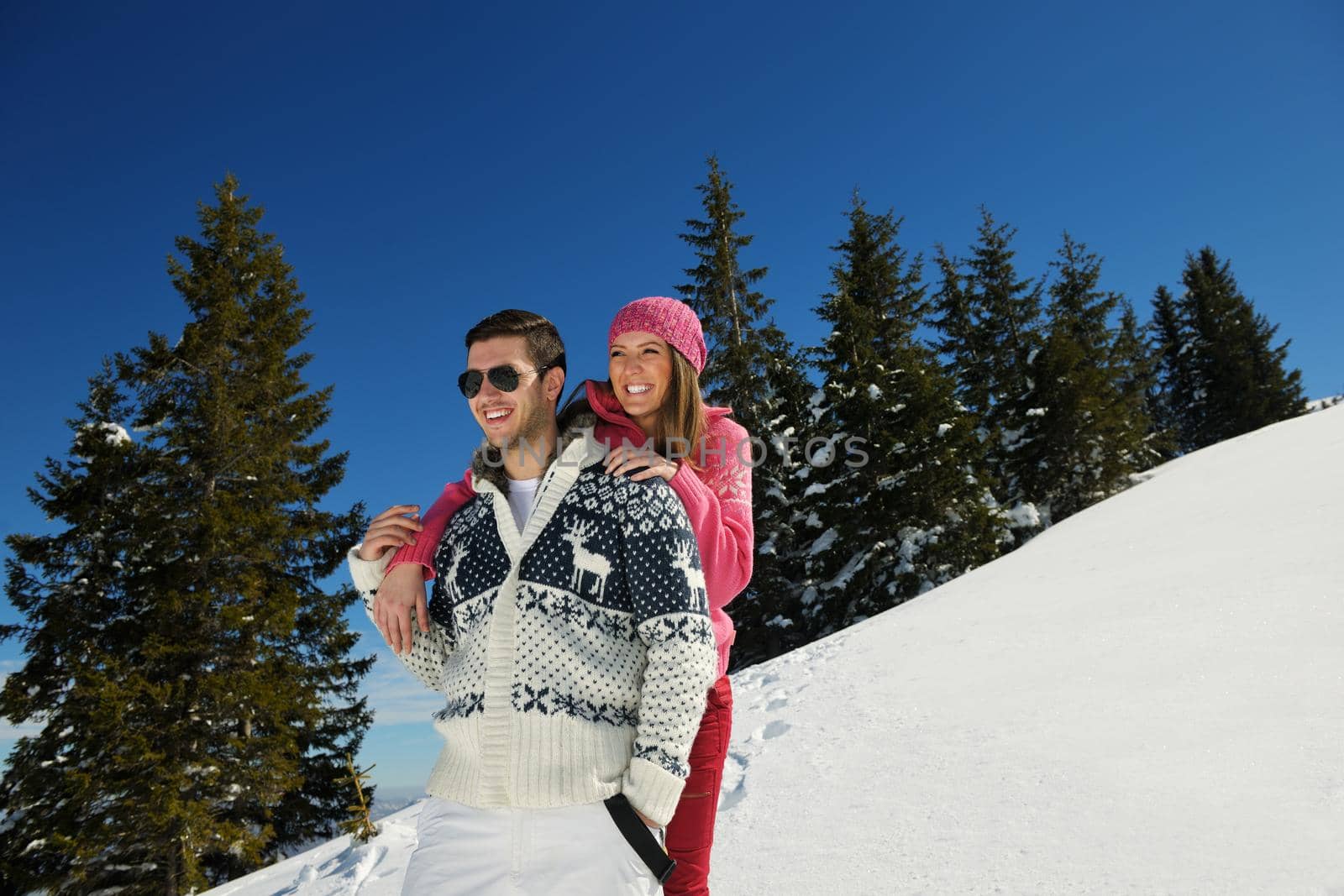 Young Couple In winter Snow Scene at  beautiful sunny day