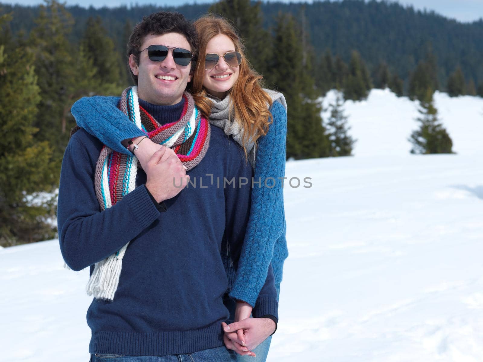 romantic winter  scene, happy young couple having fun on fresh show on winter vacatio, mountain nature landscape