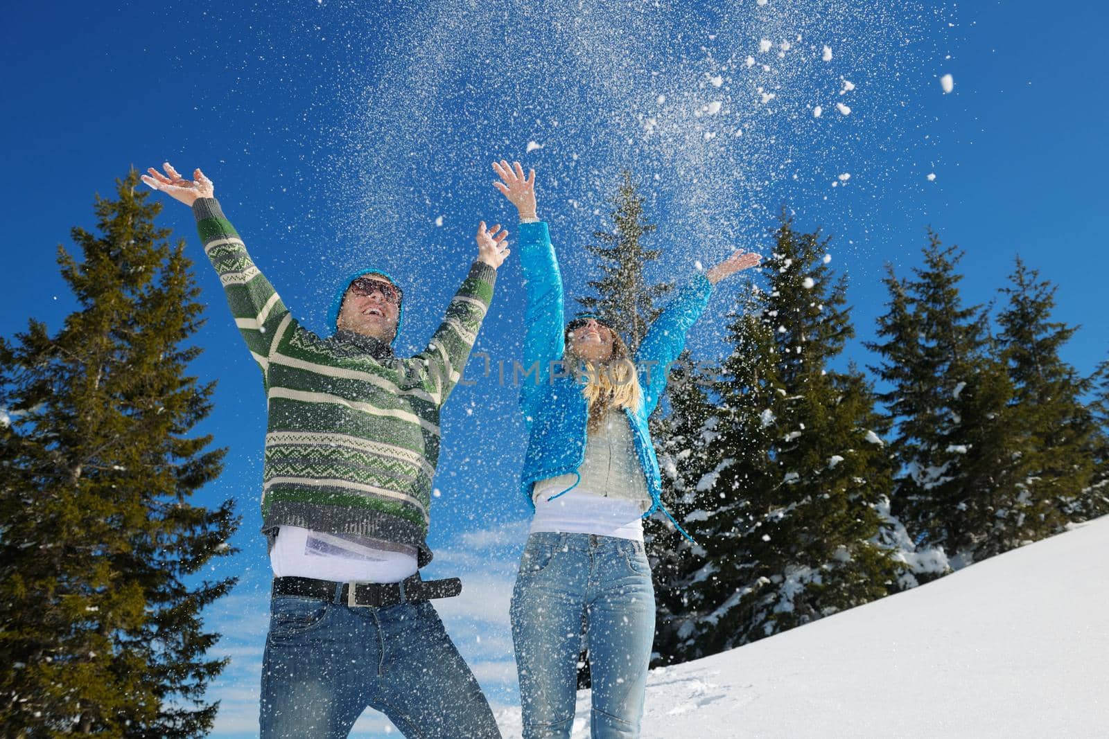 Young Couple In winter Snow Scene at  beautiful sunny day