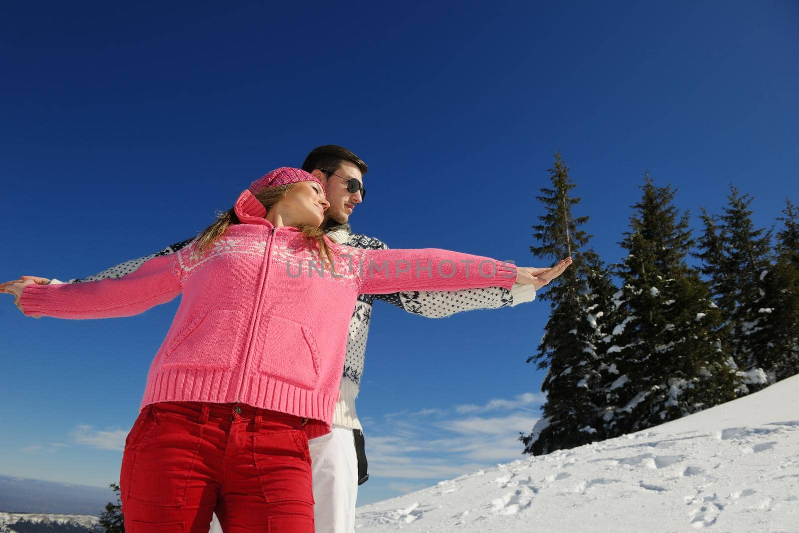 Young Couple In winter Snow Scene at  beautiful sunny day