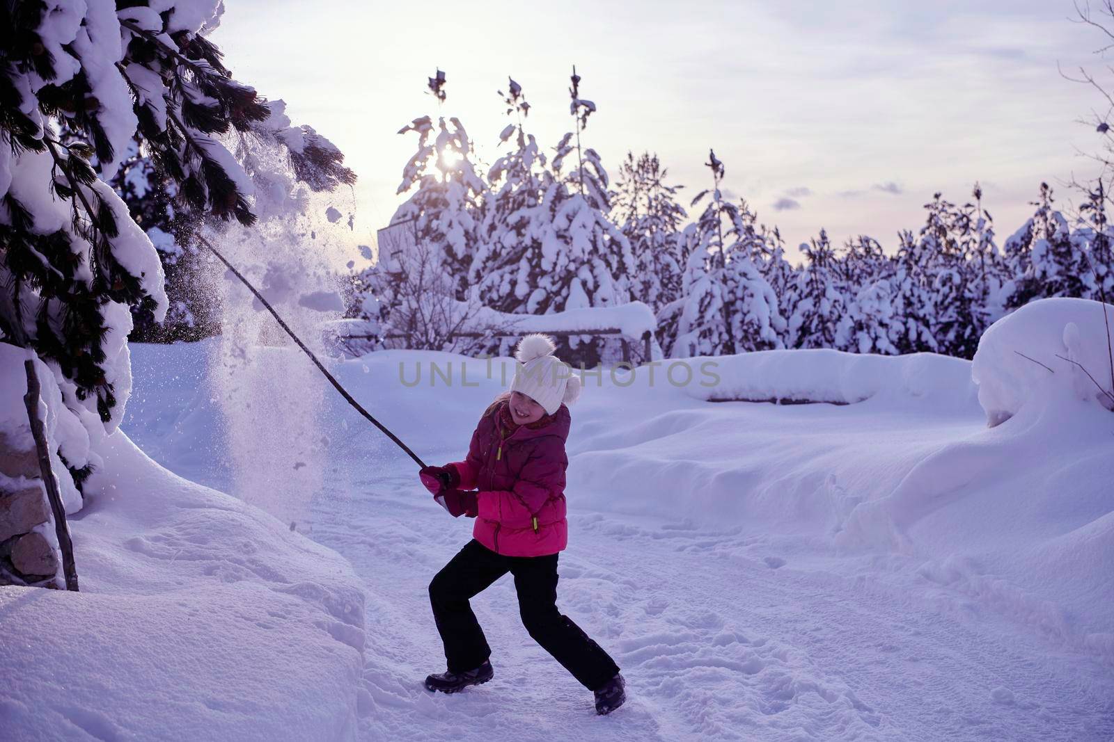 girl throwing fresh snow at beautiful sunny winter day by dotshock