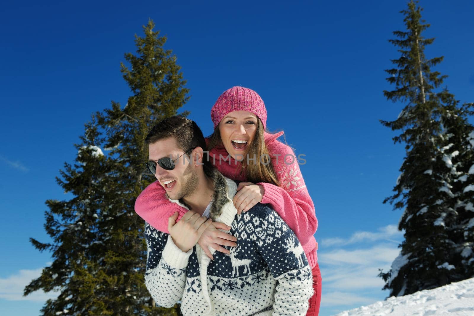 Young Couple In winter Snow Scene at  beautiful sunny day