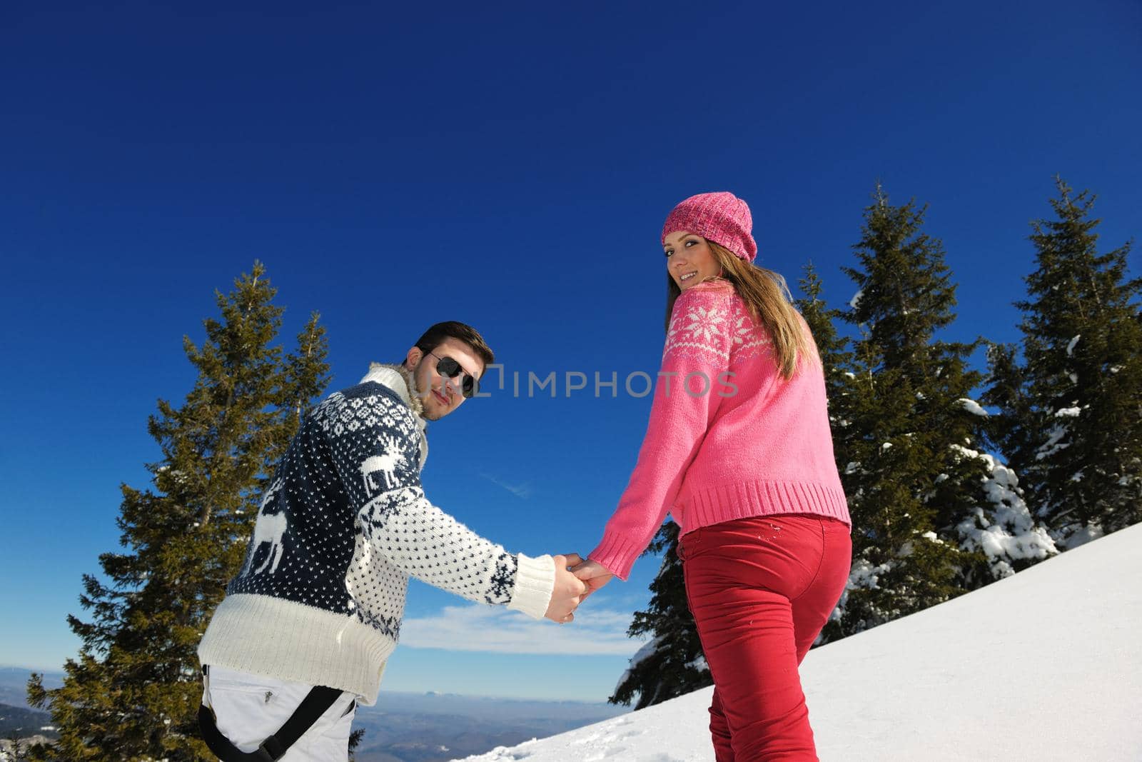 Young Couple In winter Snow Scene at  beautiful sunny day