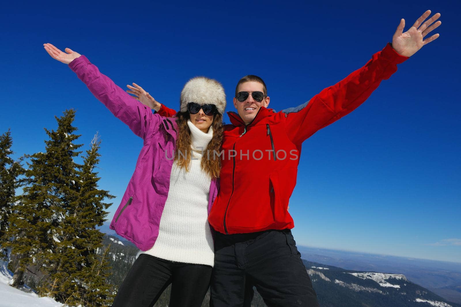 Young Couple In winter Snow Scene at  beautiful sunny day