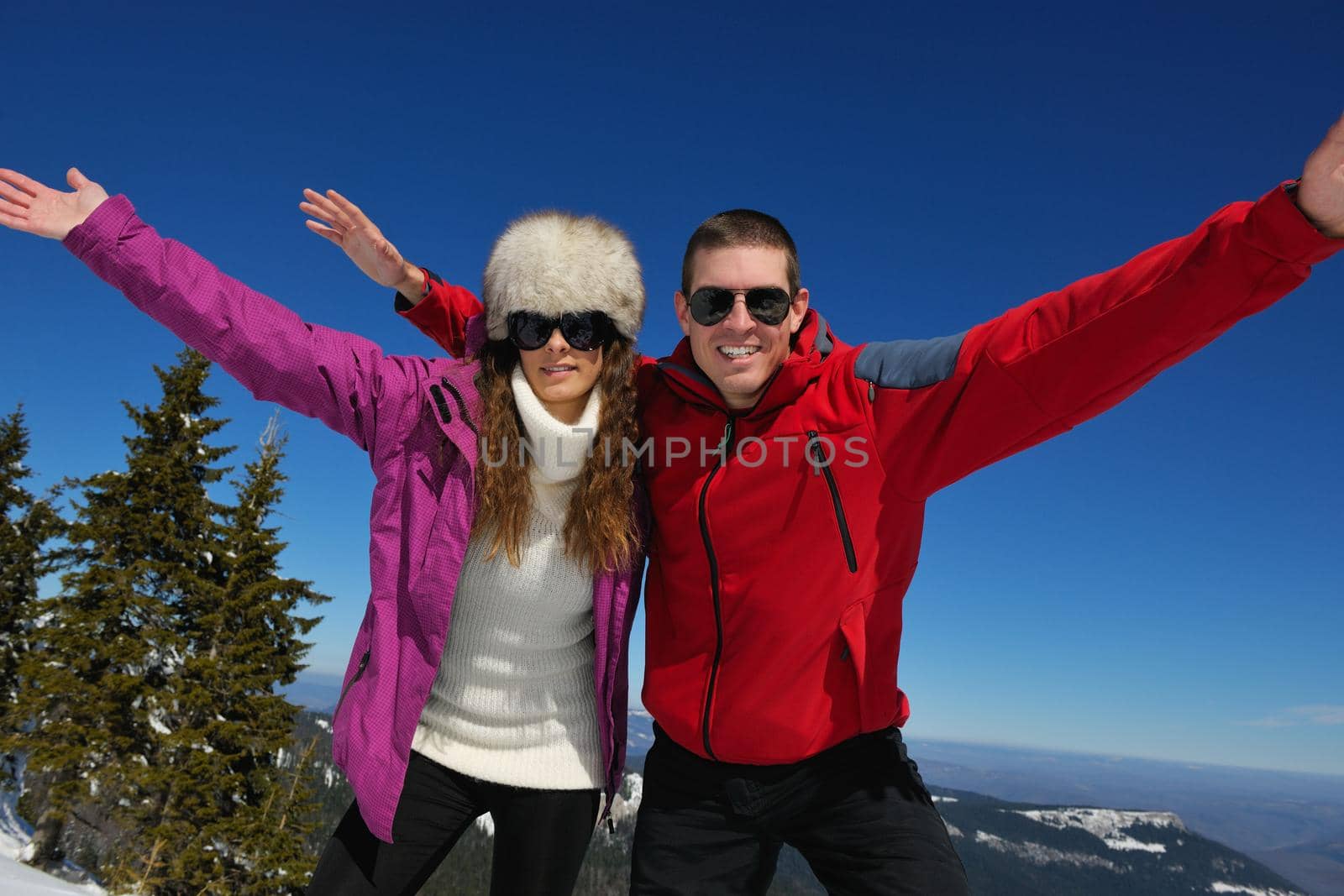 Young Couple In winter Snow Scene at  beautiful sunny day