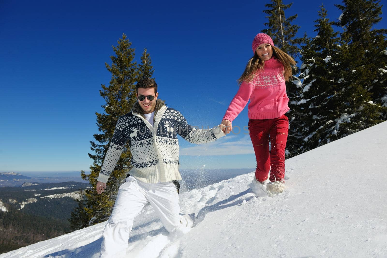 Young Couple In winter Snow Scene at  beautiful sunny day