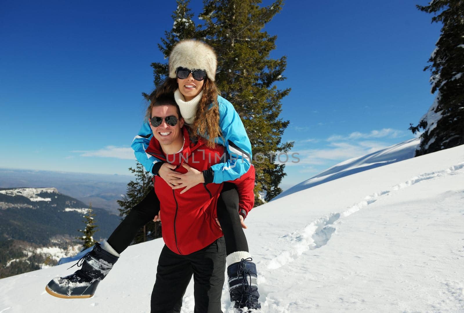 Young Couple In winter Snow Scene at  beautiful sunny day