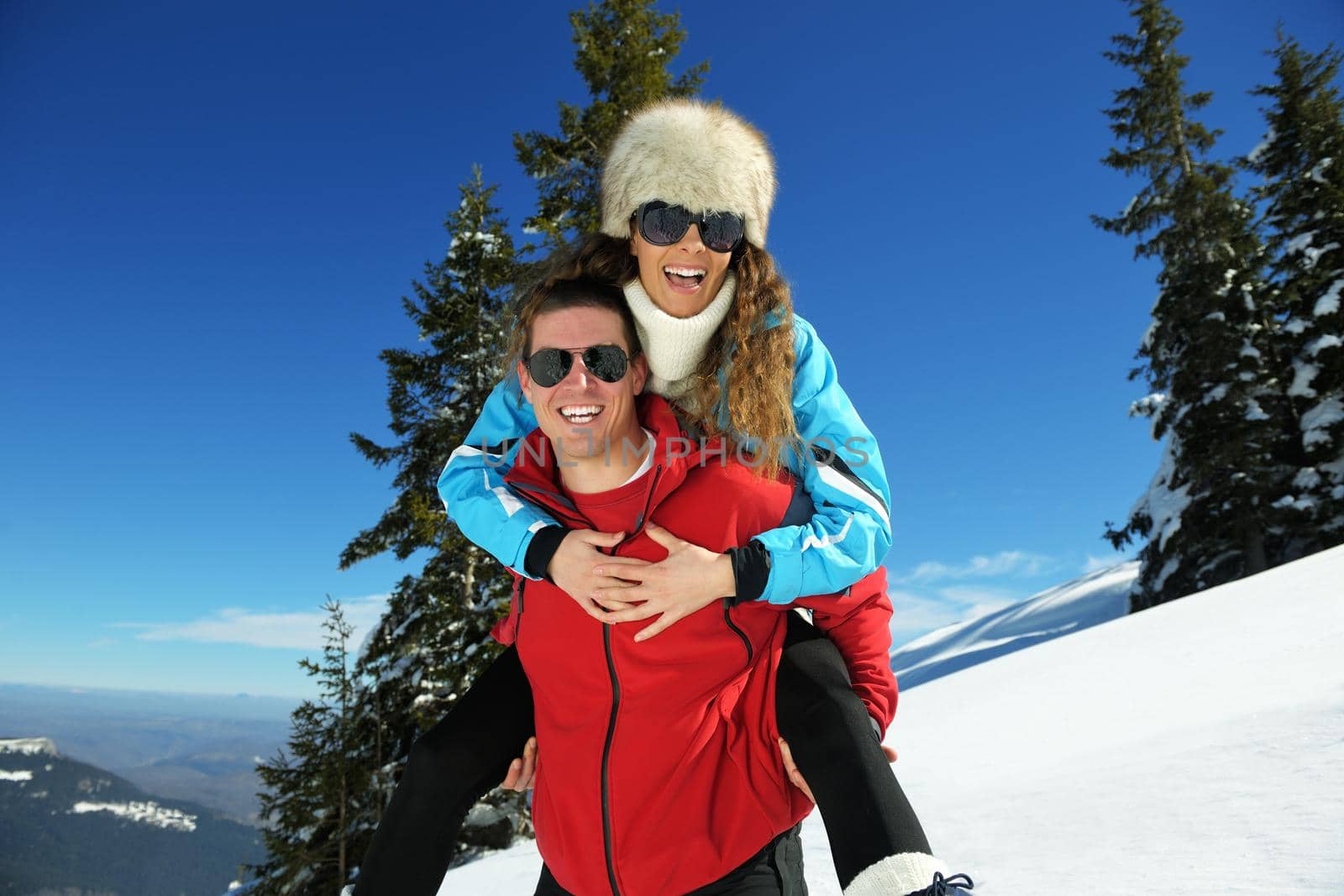 Young Couple In winter Snow Scene at  beautiful sunny day