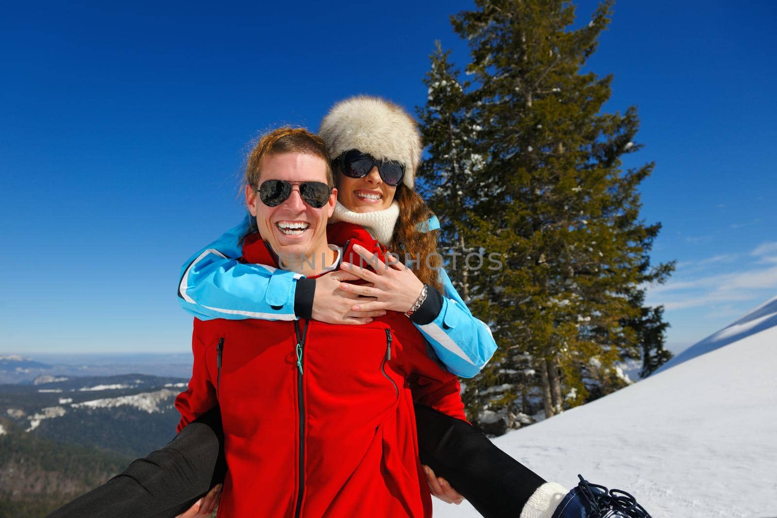 Young Couple In winter Snow Scene at  beautiful sunny day