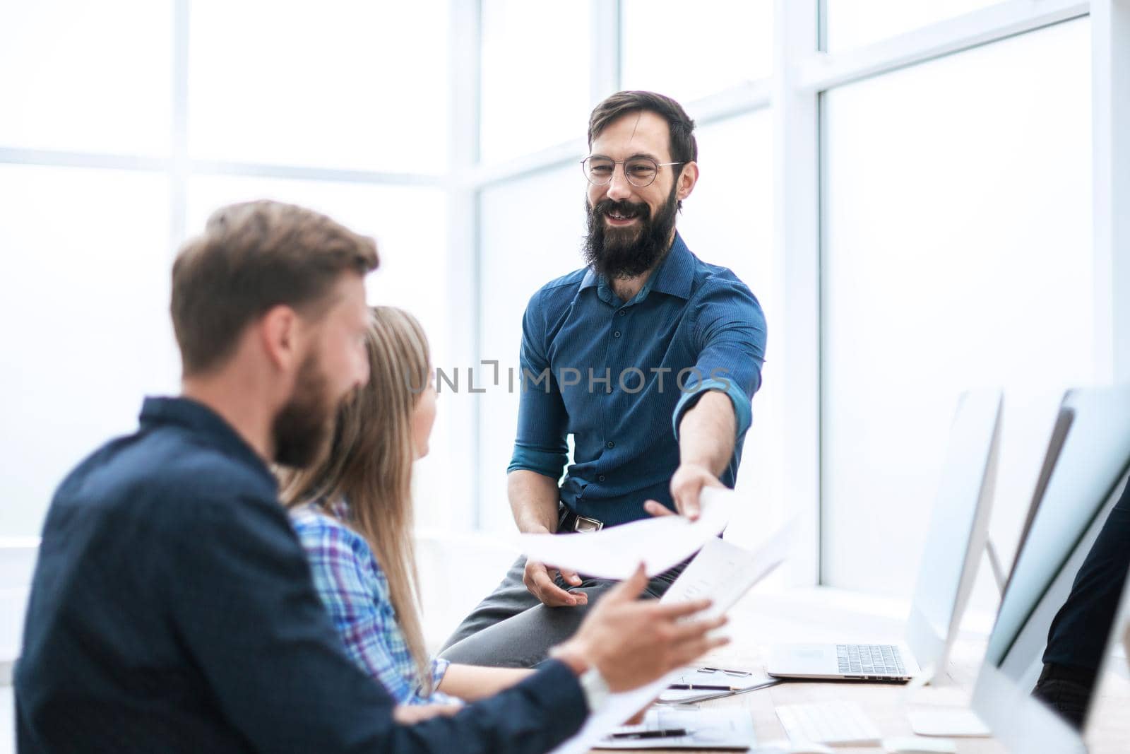 boss discussing with employees a new contract . office weekdays
