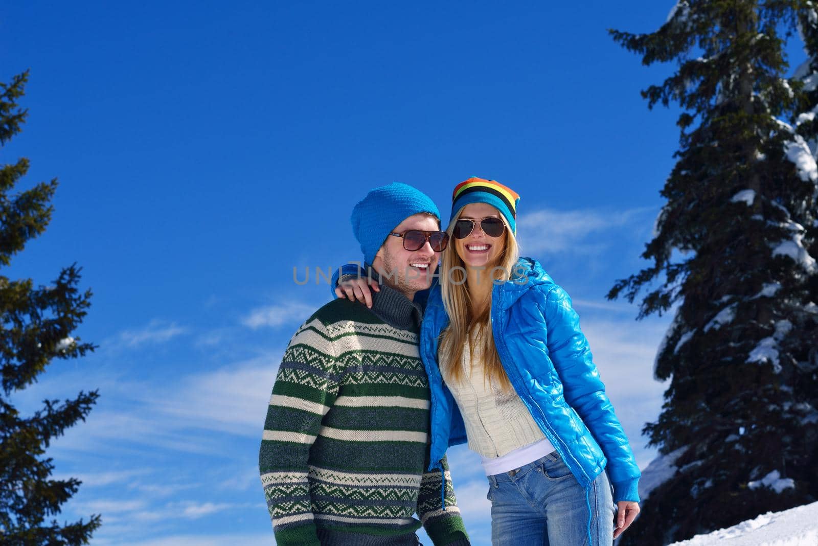 Young Couple In winter Snow Scene at  beautiful sunny day