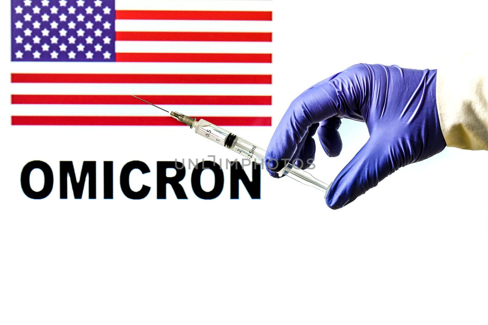 Hand holding syringe with covid vaccine. United States flag and Omicron covid variant word written in the background
