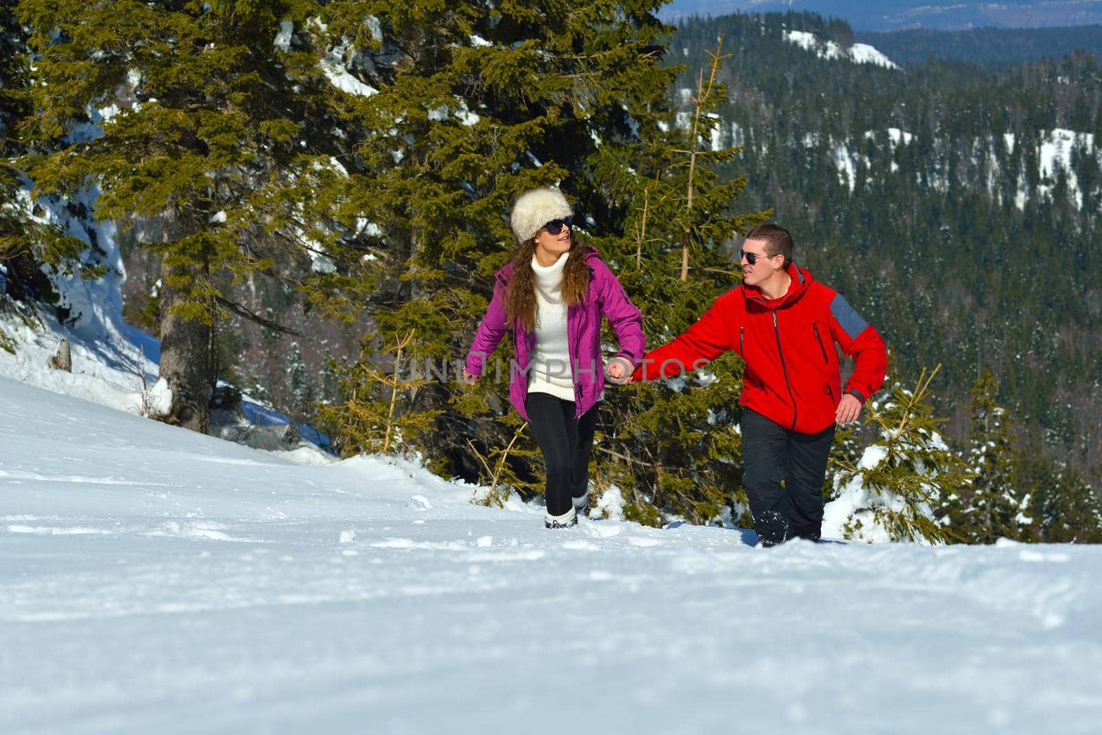 Young Couple In winter Snow Scene at  beautiful sunny day