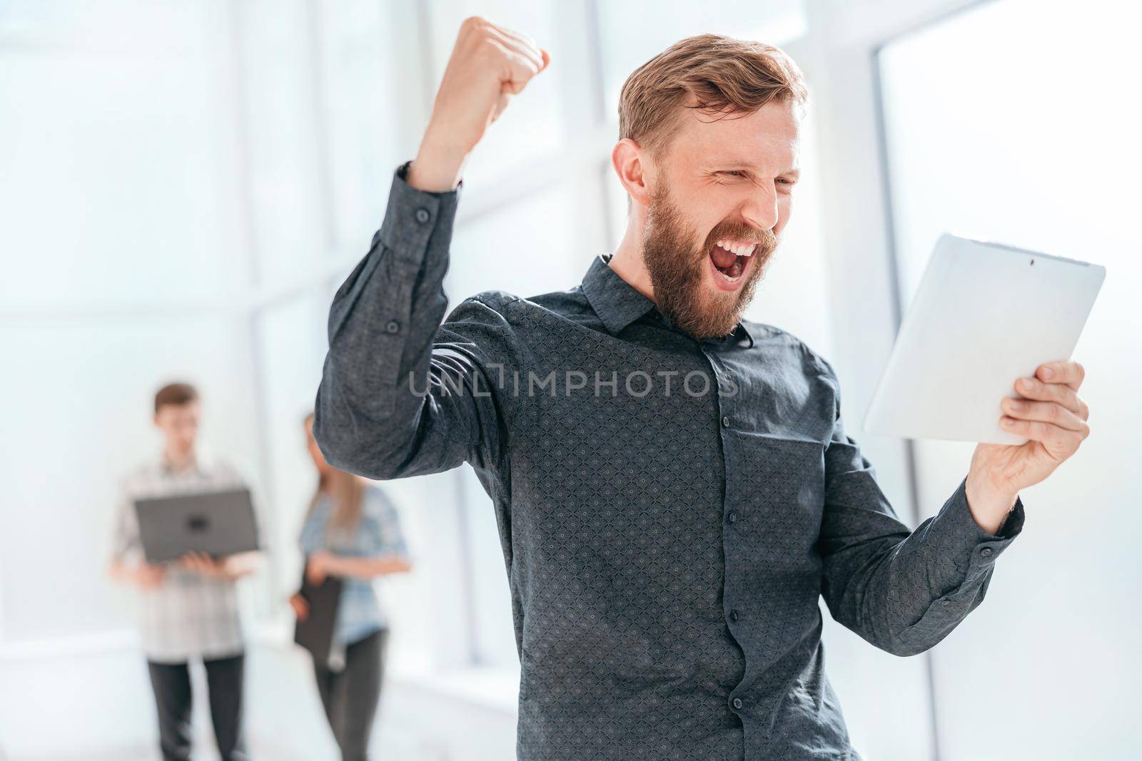 happy man reading a message on his digital tablet . photo with copy space