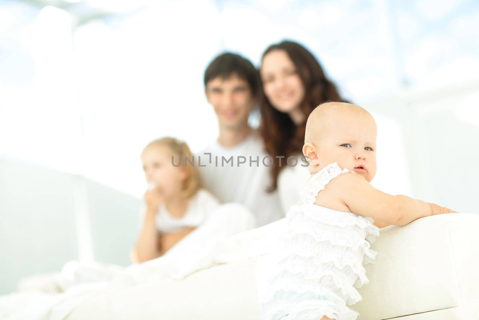 little baby on blurred background of the family.photo with copy space.the concept of parenthood