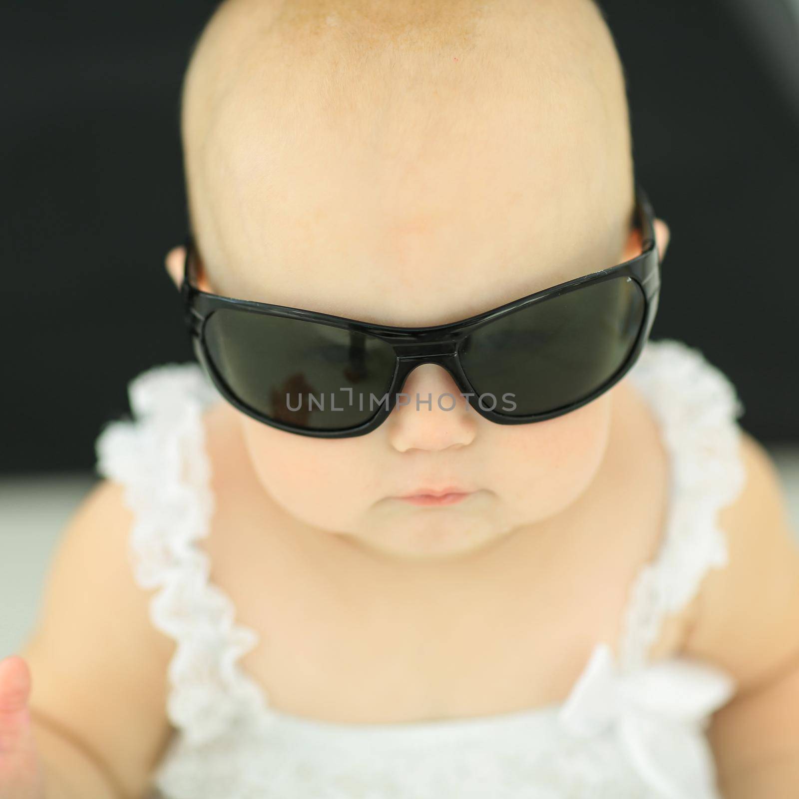 closeup.portrait of little baby with sunglasses. the concept of childhood