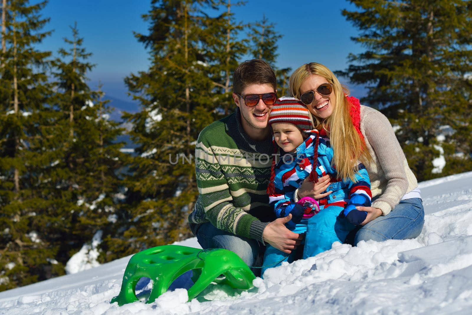 family having fun on fresh snow at winter by dotshock
