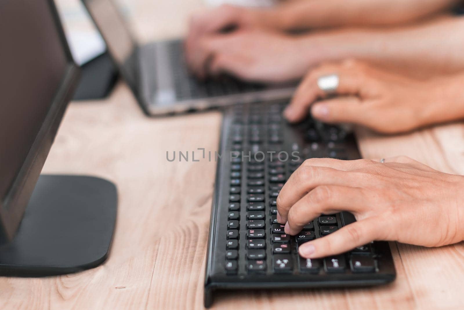 close up. a group of employees sitting at a table in a computer room. people and technology