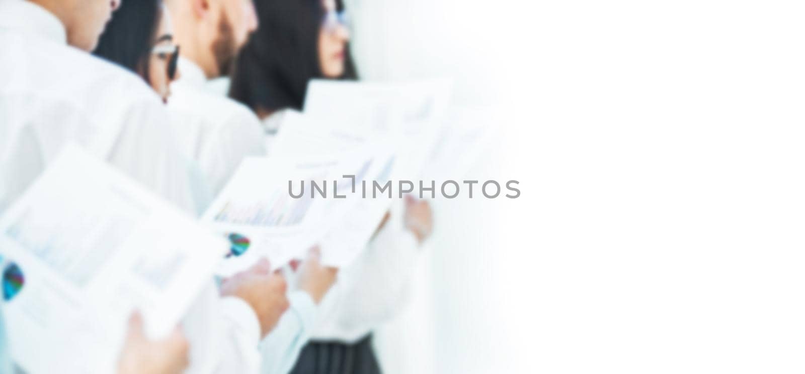blurred image for the advertising text. photo with copy space. business team with financial documents standing in the office. by SmartPhotoLab