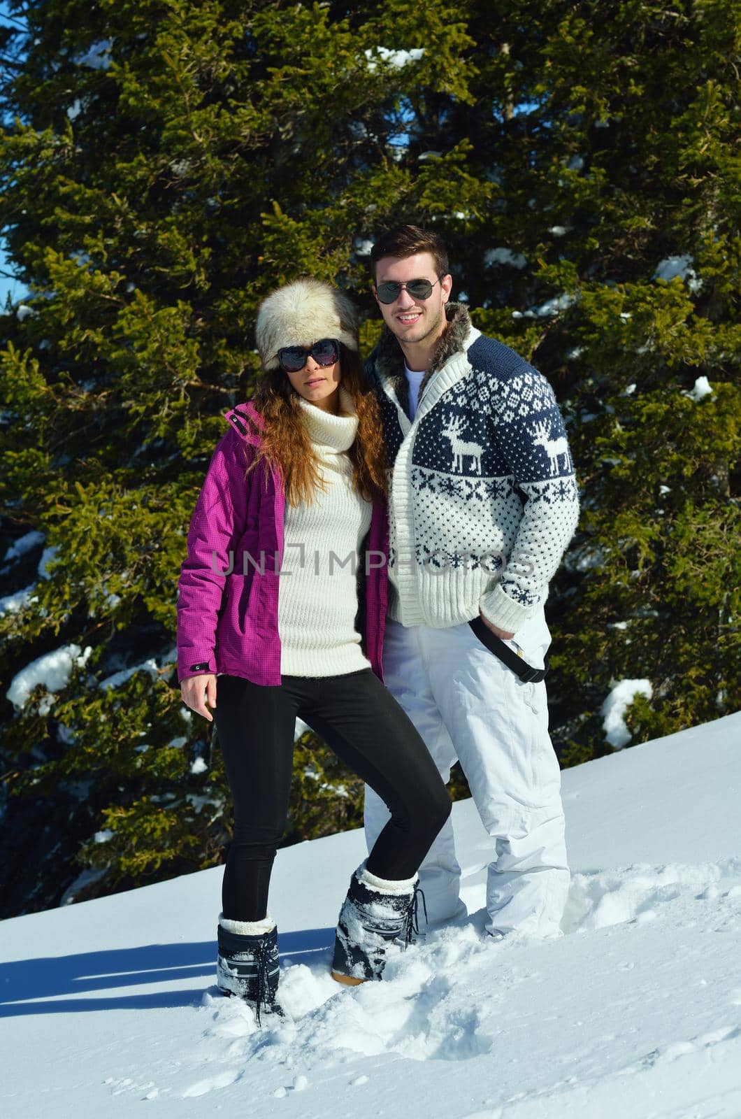 Young Couple In winter Snow Scene at  beautiful sunny day