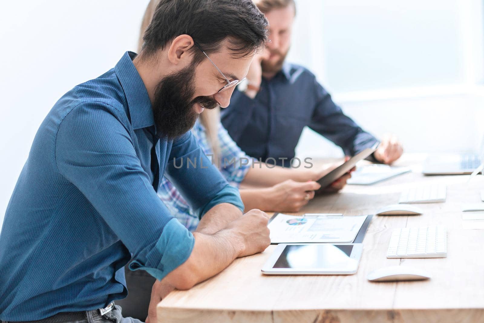 business man uses of the digital tablet to work with financial documents