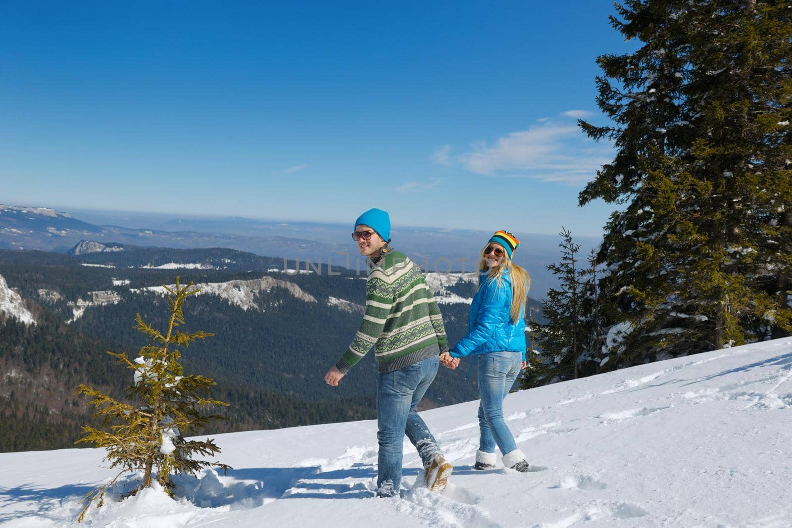 Young Couple In winter Snow Scene at  beautiful sunny day