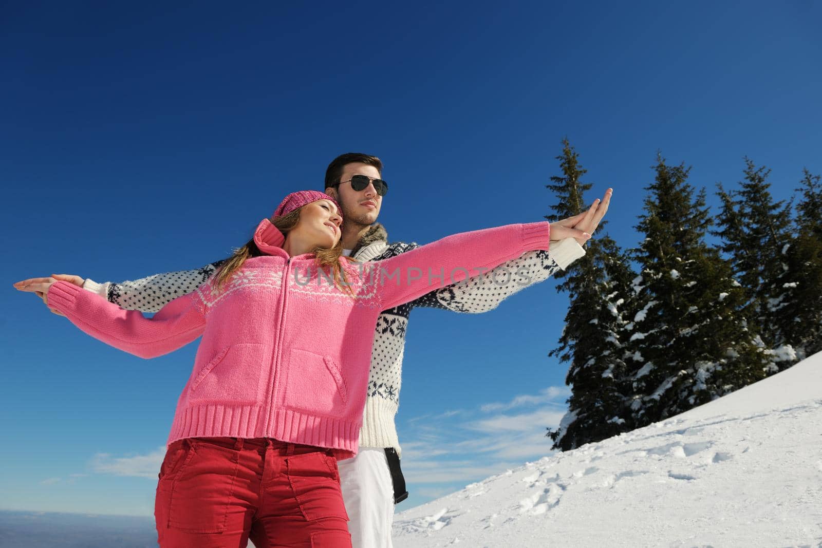 Young Couple In winter Snow Scene at  beautiful sunny day