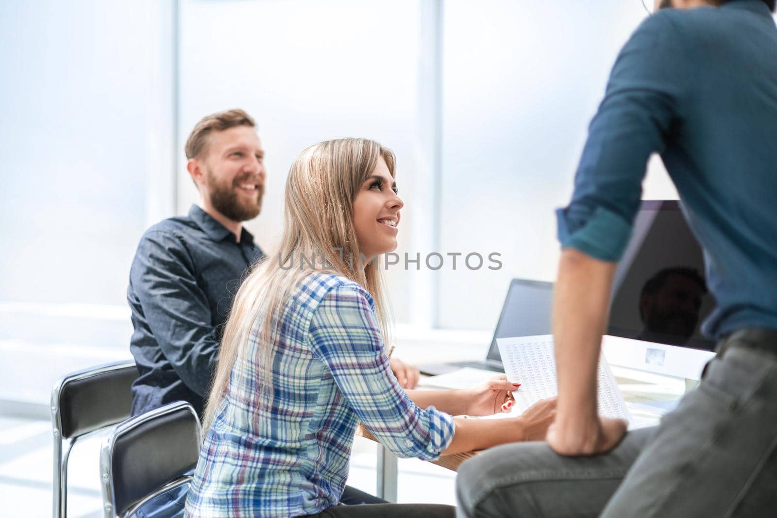 young employee discussing business documents with colleagues. office weekdays