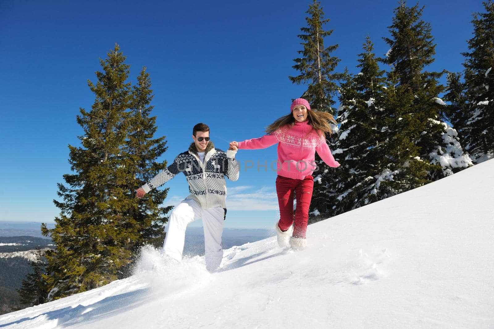 Young Couple In winter Snow Scene at  beautiful sunny day