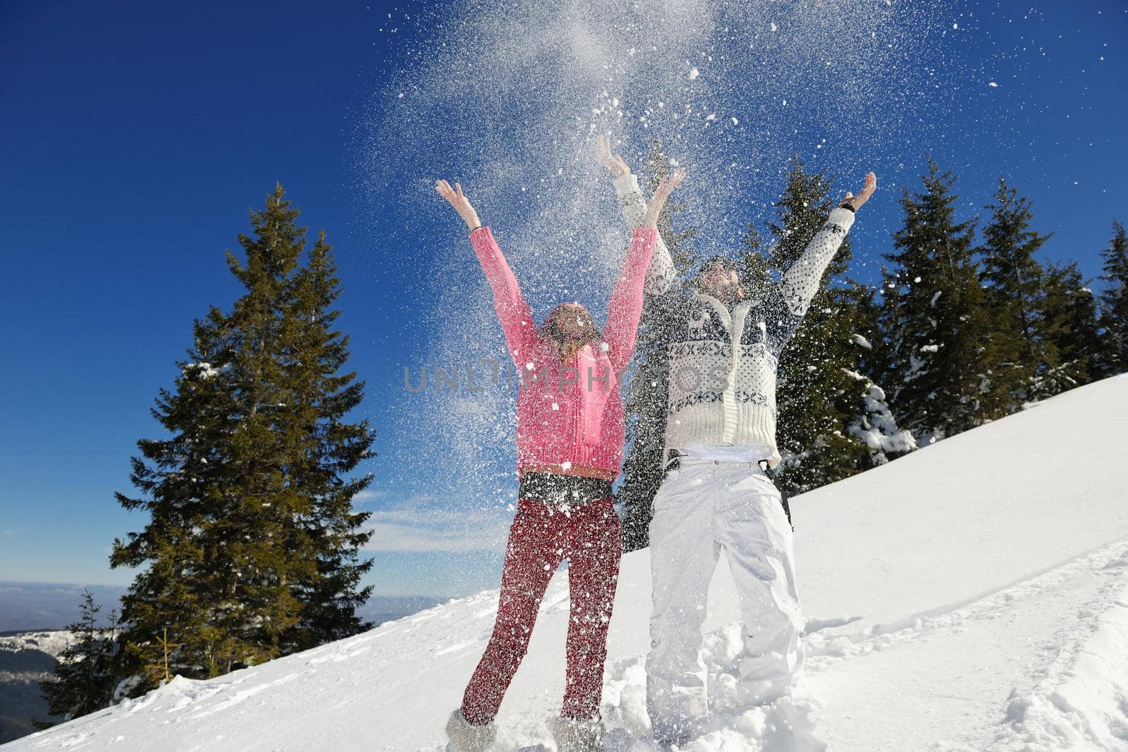 Young Couple In winter Snow Scene at  beautiful sunny day