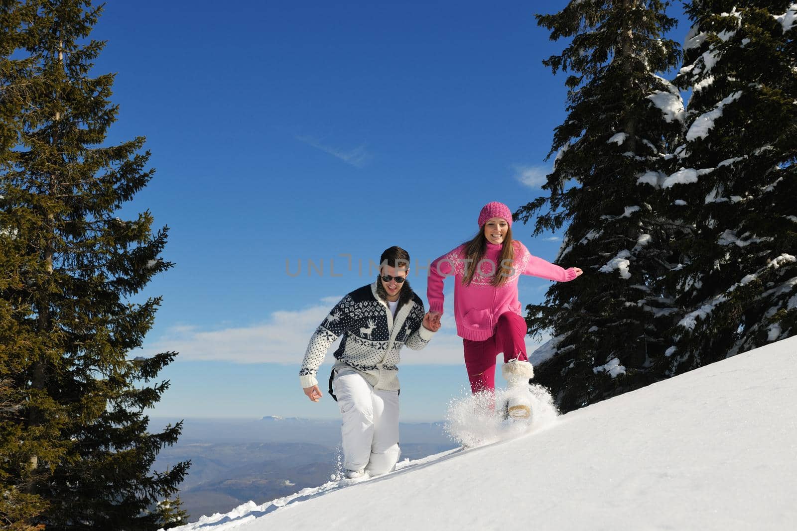 Young Couple In winter Snow Scene at  beautiful sunny day